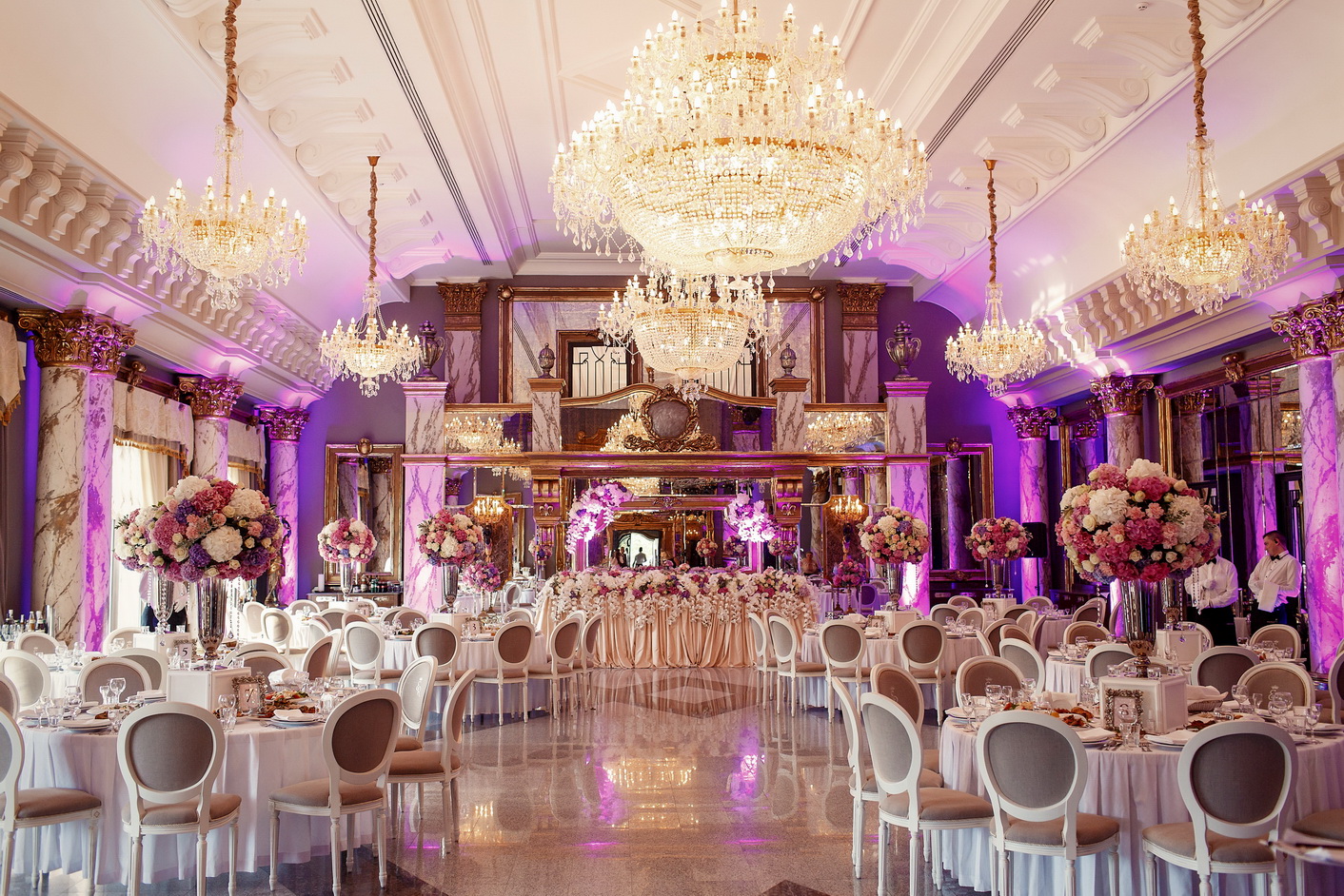 Luxurious dinner hall with large crystal chandeliers hanging from the ceiling